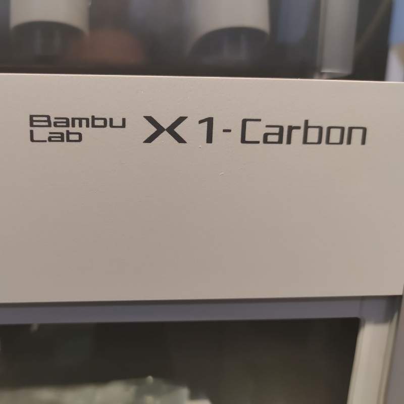 The bambu x1 carbon is sitting on a table.