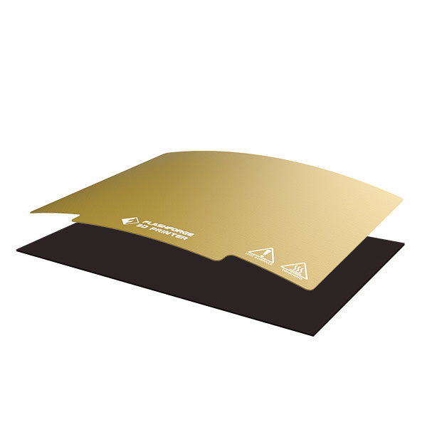 The "PEI Sheet and Magnet Tape Assembly for Creator Pro Series" by Flashforge features a flexible, gold-colored 3D printer build plate that is partially detached from its black magnetic base, enhanced by durable magnet tape to ensure secure attachment during the 3D printing process.