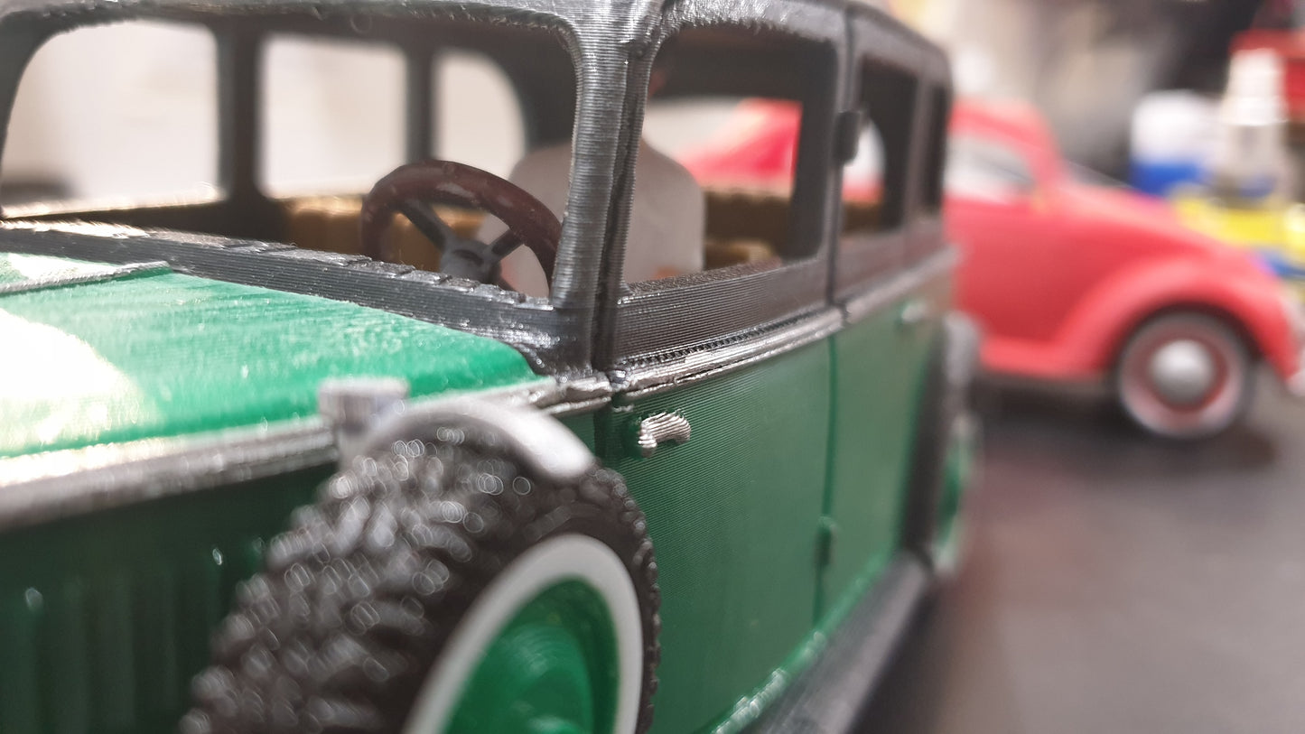 Close-up of a green **1930 Mercedes Vehicle STL File** by **Gordon Nezich** with detailed wheels and interior, with a red classic car model slightly blurred in the background.