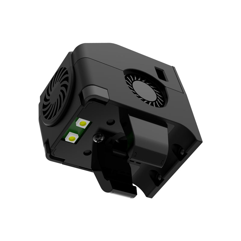 A black, cube-shaped electronic device featuring vents and two green buttons on its side, evokes the modern design of Flashforge's Extruder Assembly for the Adventurer 4 Pro 3D Printer, viewed from an angled perspective.