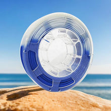 A spool of blue 1.75mm Hello3D PLA Temperature Change Colours 3D Printing Filament, exhibiting Thermochromic Magic, sitting on top of a rock.