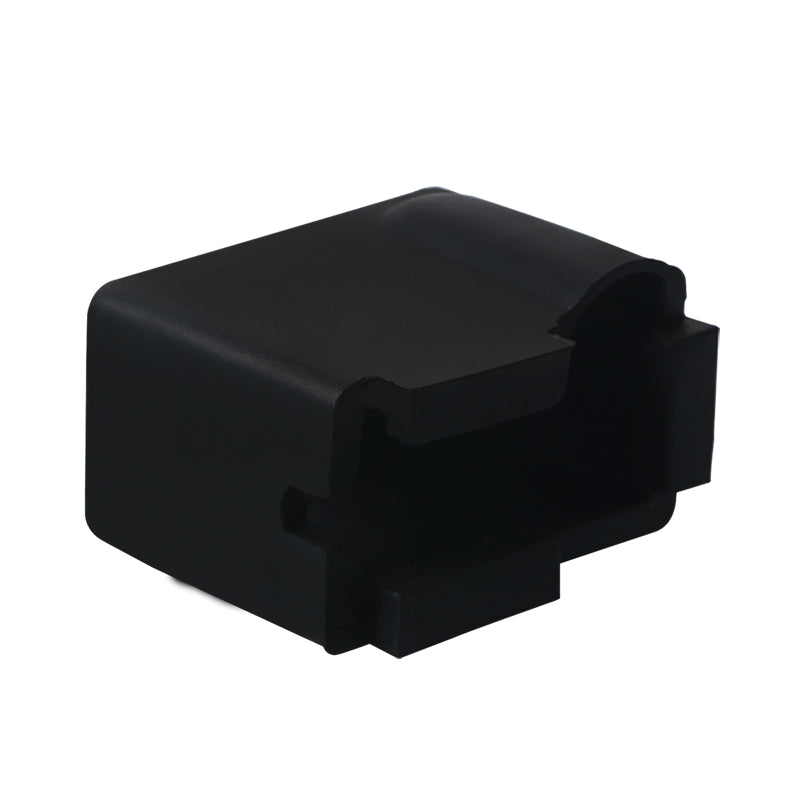 The E3D PT100 Volcano Block silicone Case Insulation Cover by 3D Printing Perth - Cirrus Link is a black rectangular cover with hollow sections and notches, viewed from an angle, ideal for thermal management in 3D printing.