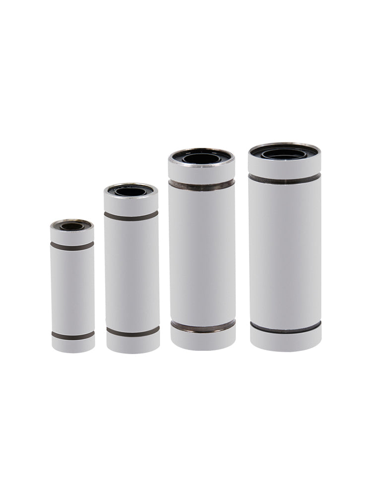 Four Extended Linear Ball Bearings of varying sizes, made by 3D Printing Perth - Cirrus Link with silver casings and crafted using CNC machines for precision movement, are arranged in ascending order.