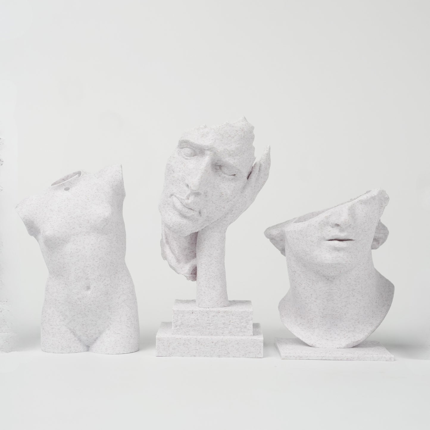 Three sculptures 3D printed with Flashforge HS PLA 1.75mm Filament in Marble Colour stand against a plain white background, each featuring a smooth surface finish that highlights the quality of Flashforge’s material.