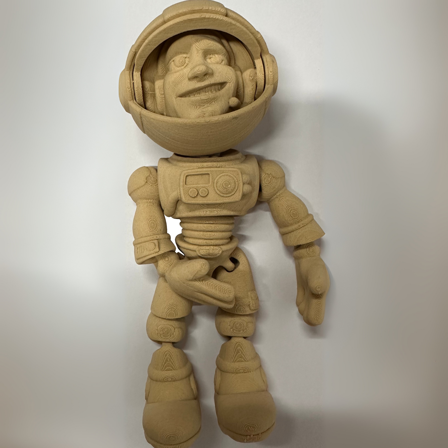 A wooden toy astronaut figure with helmet and jointed limbs, 3D printed using Flashforge PLA Wood 1.75mm filament, posed upright against a plain background.