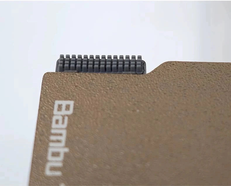 A close-up view of a silicone nozzle wiper brush set by Bambu Lab, echoing the precision associated with 3D printer maintenance tools, displayed on a white background.