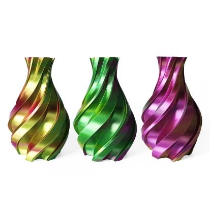 Three 3d printed vases in different colors.
