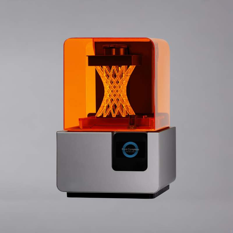 An orange 3d printer on a grey background.