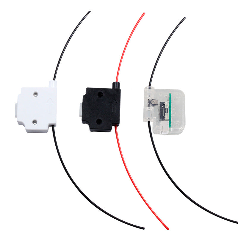 Three optical fiber signaling devices in black, white, and transparent casings highlight advanced technology. These 3D Printing Perth Cirrus Link filament detectors identify broken filaments, boosting precision and reliability in complex systems.