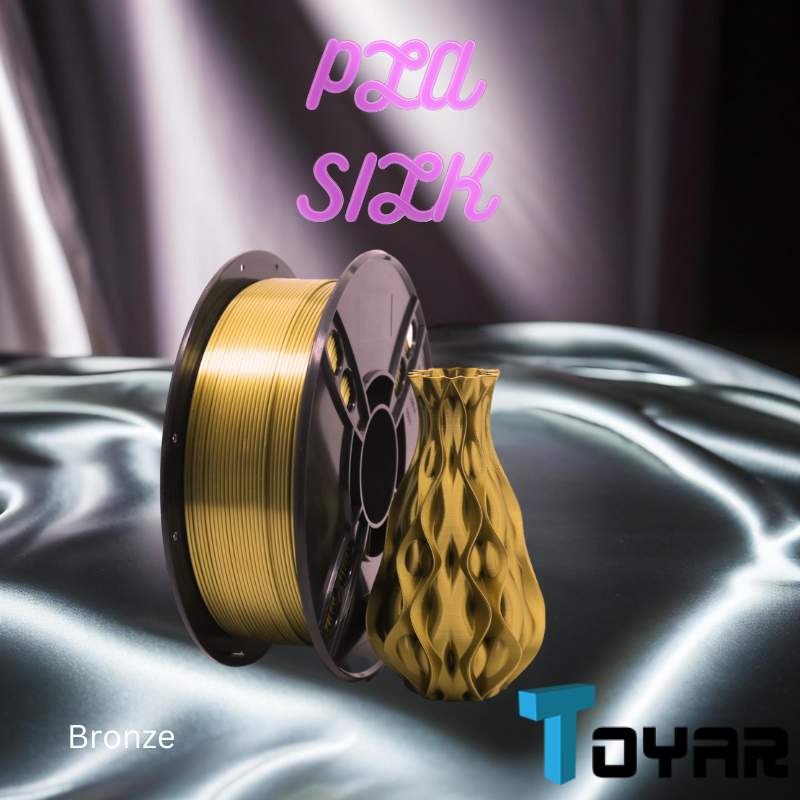 A gold spool of Toyar PLA Silk Standard Colour 1.75mm 3D Printing Filament on a silver 3D printing surface.