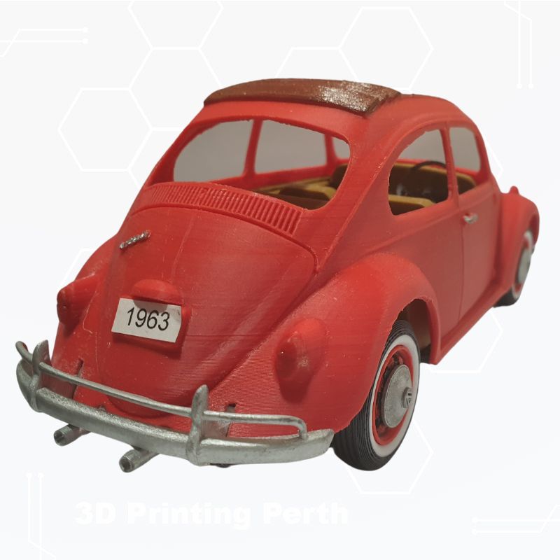 A 3D-printed model of a red classic car with a "1963" license plate is shown from the rear. The model includes detailed features like a silver bumper and a brown interior, capturing the essence of automotive nostalgia. Perfect for enthusiasts, this STL File : 1963 VW Beetle Vehicle by Gordon Nezich brings the charm of a 1963 VW Beetle to life.