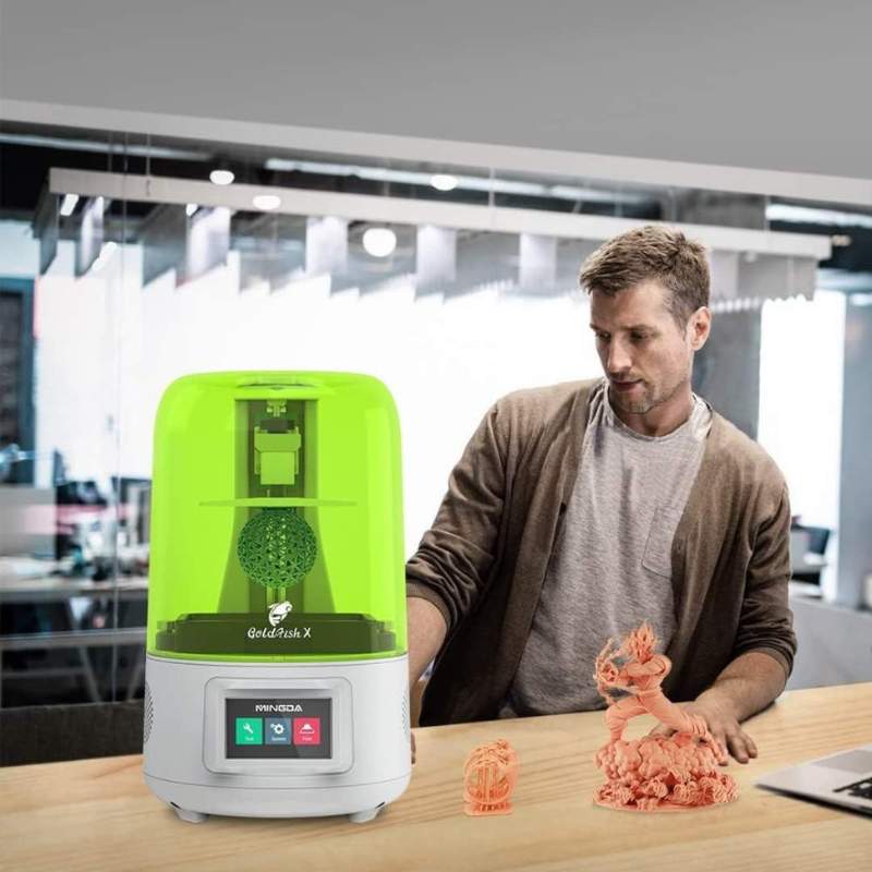 A man is standing next to a MINGDA Goldfish X 2K Resin Printer.
