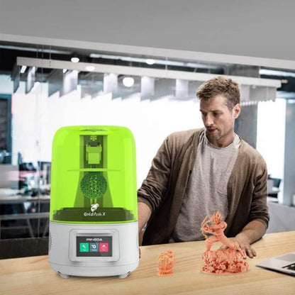 A man is standing next to a MINGDA Goldfish X 2K Resin Printer.