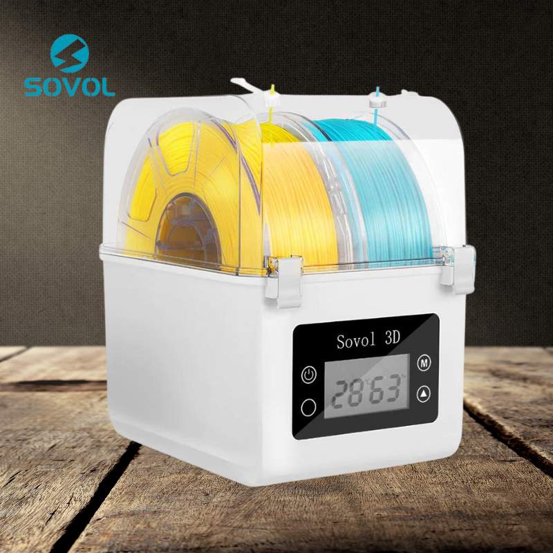 A SOVOL Sovol Filament Dual Bay Dryer SH01 with yellow and blue filament spools and a digital display reading "2863" sits on a wooden surface.