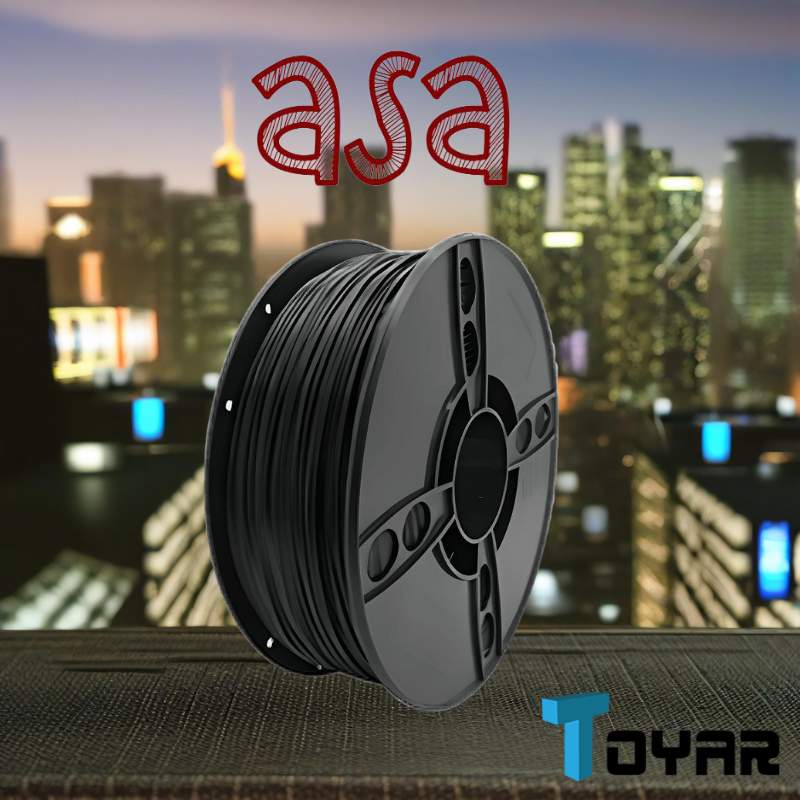 A spool of black Toyar ASA 1.75mm 3D Printing Filament on a table in front of a city.