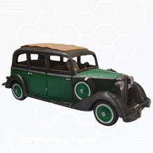A 3D-printed model of a vintage green and black 1930s Mercedes car with a brown roof, showcased on a white background. The text "STL File : 1930 Mercedes Vehicle by Gordon Nezich" appears faintly at the bottom.