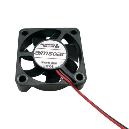A compact black computer cooling fan labeled as "aimsoar," featuring red and black wires, functions as a 12V DC fan from the brand 3D Printing Perth - Cirrus Link with specifications of 40x40x10mm, dual ball bearing, operating at 6512 RPM, producing 23 DBA noise level and providing airflow of 6.5 CFM at a current of 0.1 A.