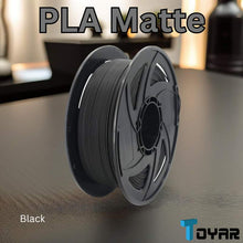A spool of Toyar PLA Matte 1.75mm 3D Printing Filament with a matte finish on a table.