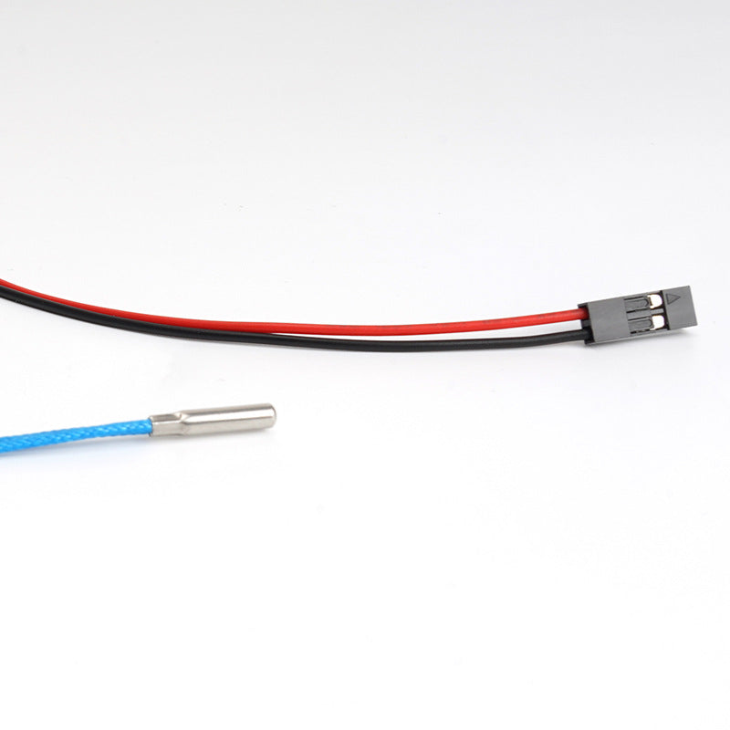 A close-up of the PT1000 High Temperature Platinum Thermistor Sensor Probe by 3D Printing Perth - Cirrus Link features black and red wiring with a metal sensor tip, perfect for precise temperature monitoring in 3D printing.