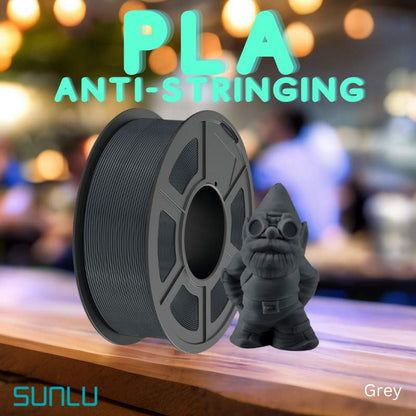 A teddy bear is sitting on a table next to a spool of SUNLU APLA 1.75mm 3D Printing Filament.