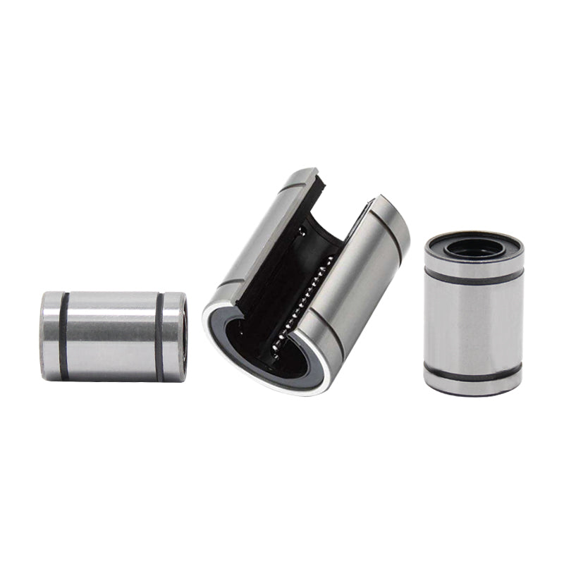 Displayed are three Linear Ball Bearings by 3D Printing Perth - Cirrus Link; two cylindrical and one open to reveal internal components, exemplifying CNC machining precision.