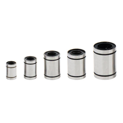Five varying-sized linear ball bearings from 3D Printing Perth - Cirrus Link, neatly arranged in a row against a white background, showcasing precision akin to CNC machining.