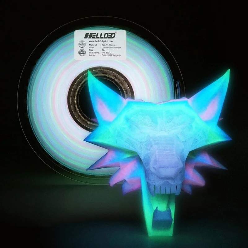 A glowing head of a wolf next to a spool of Hello3D PLA Glow In The Dark 1.75mm 3D Printing Filament by Hello3D.