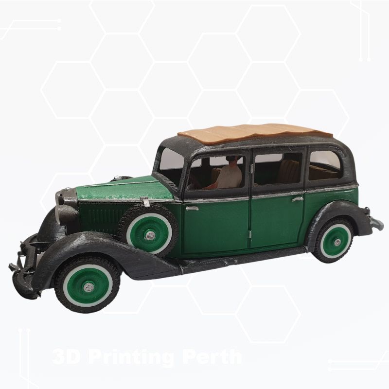 A green and black STL File : 1930 Mercedes Vehicle by Gordon Nezich with a tan roof, viewed from a side angle, set against a white background. The text "3D Printing Perth" is faintly visible at the bottom.