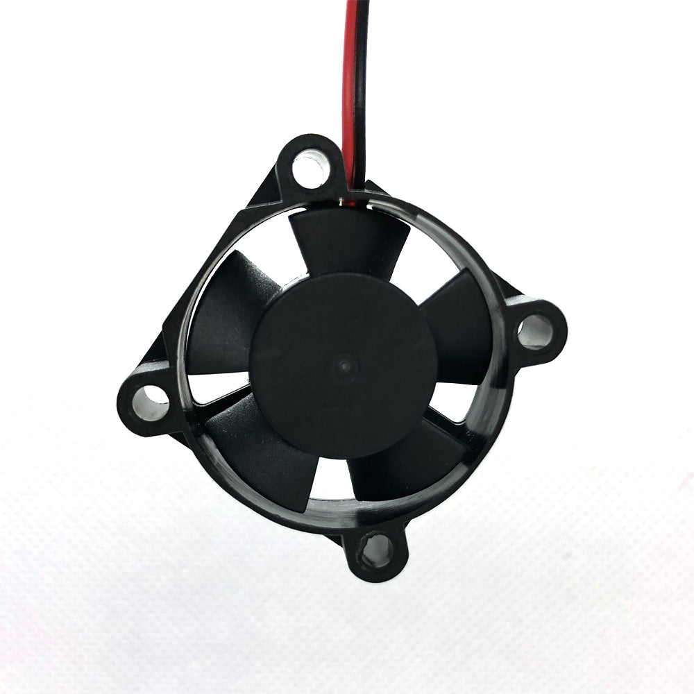 The 24V Dual Ball Bearing Cooling Fan 3010 by 3D Printing Perth - Cirrus Link is a compact, black electronic cooling fan measuring 30mm x 30mm x 10mm. It features five blades and a red and black wire attached, spinning at 8262 RPM to enhance the efficiency of your 3D printer with a flow rate of 4.5 CFM at just 24 dBA noise level.