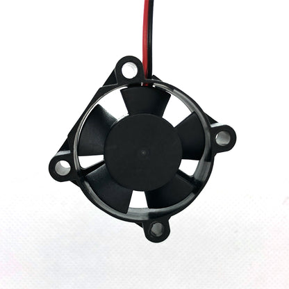 The 24V Dual Ball Bearing Cooling Fan 3010 by 3D Printing Perth - Cirrus Link is a compact, black electronic cooling fan measuring 30mm x 30mm x 10mm. It features five blades and a red and black wire attached, spinning at 8262 RPM to enhance the efficiency of your 3D printer with a flow rate of 4.5 CFM at just 24 dBA noise level.