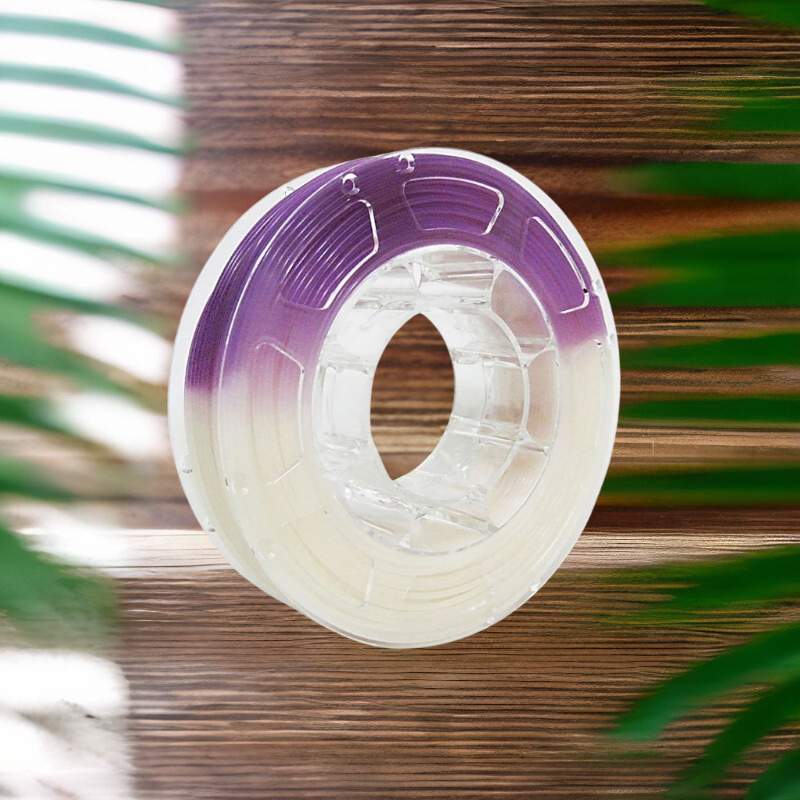 A spool of purple Hello3D PLA Light Change Colours 1.75mm 3D Printing Filament on a wooden surface for 3D printing.