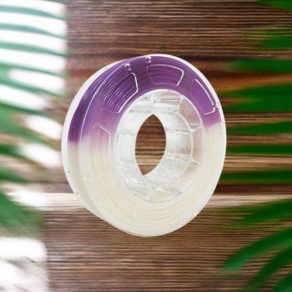 A spool of purple Hello3D PLA Light Change Colours 1.75mm 3D Printing Filament on a wooden surface for 3D printing.