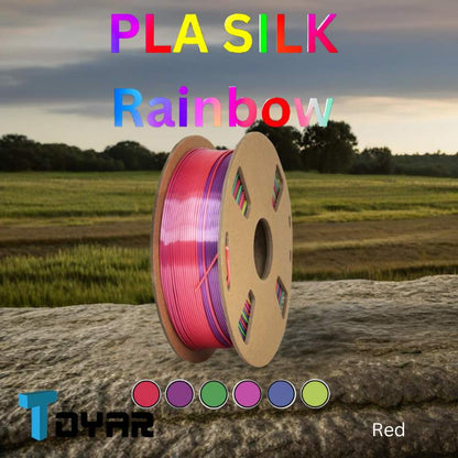 A spool of Toyar PLA Silk Rainbow filament in a field.