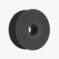 The Bambu Lab Bambu Reusable Spool for Refillable Filament is a black, perforated cylindrical spool with a large central hole, perfect for filament storage, shown against a plain white background.