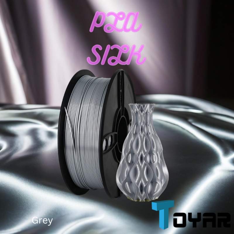 A stack of Toyar PLA Silk Standard Colour 1.75mm 3D Printing Filament on a silver surface, showcasing the vibrant colors and smooth texture of standard silk PLA.
