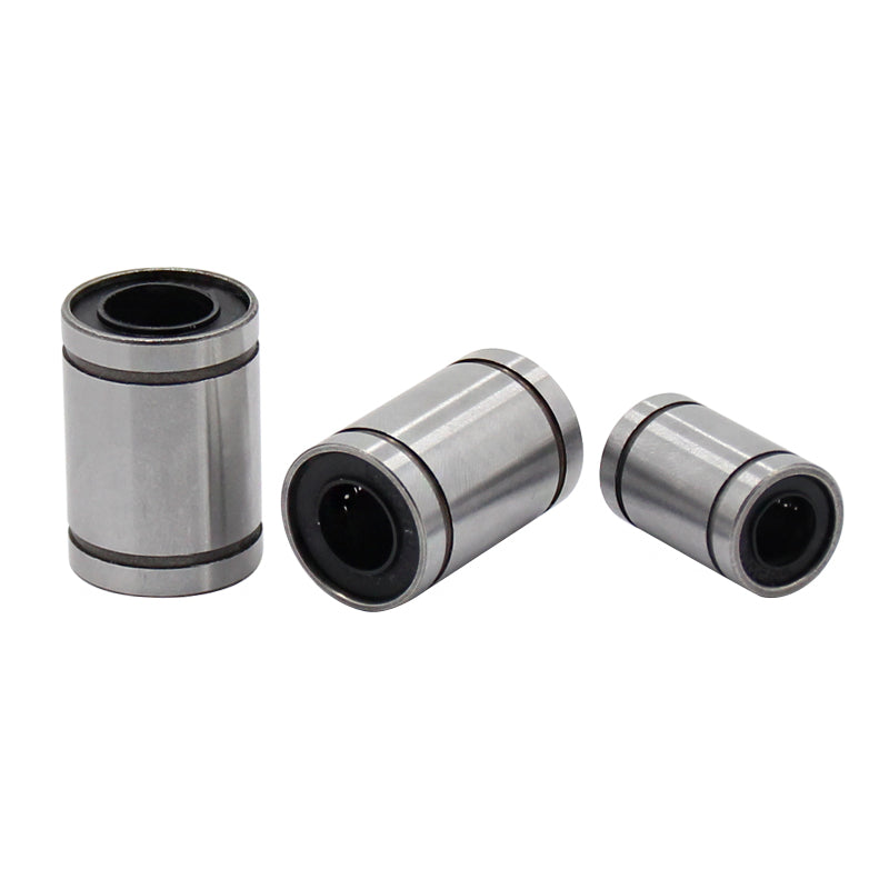 Three Linear Ball Bearings by 3D Printing Perth - Cirrus Link, ideal for CNC machining applications, lay on a white background.