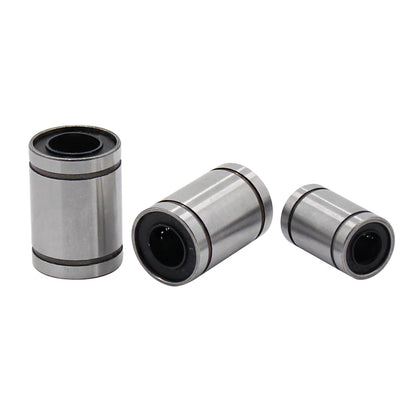 Three Linear Ball Bearings by 3D Printing Perth - Cirrus Link, ideal for CNC machining applications, lay on a white background.