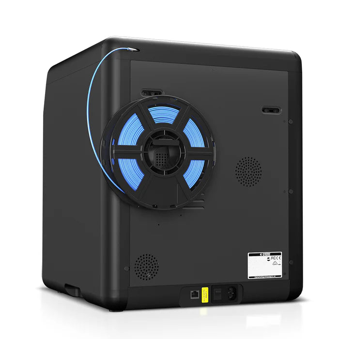 Back view of the FlashForge Adventurer 5M Pro 3D printer in black, with a blue filament spool mounted on the side and power/connectivity ports at the bottom. Quick & Easy Setup by FlashForge makes it perfect for home or school use.
