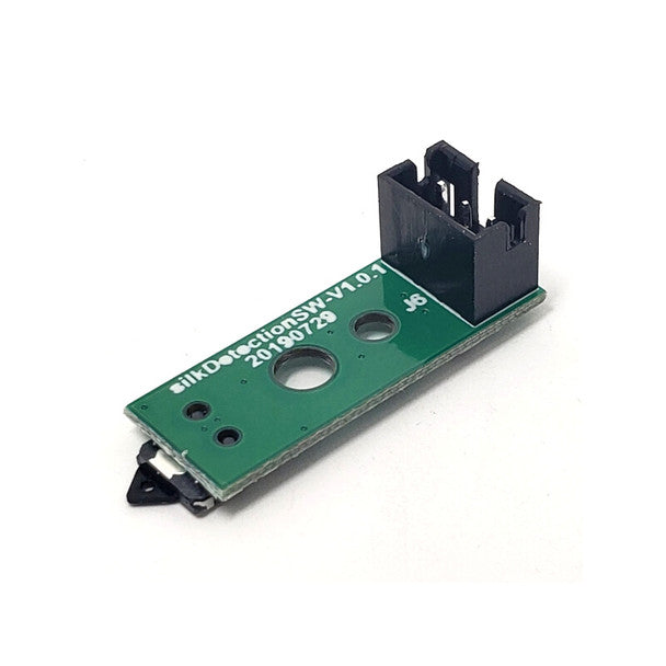 A close-up of a green circuit board labeled "ilk Detection SWV1.0.1" highlights its value as the Filament Runout Sensor for Flashforge Adventurer 2/3/4. It has a black plastic connector with circular holes and various electronic components, making it an ideal 3D printing accessory by FlashForge.