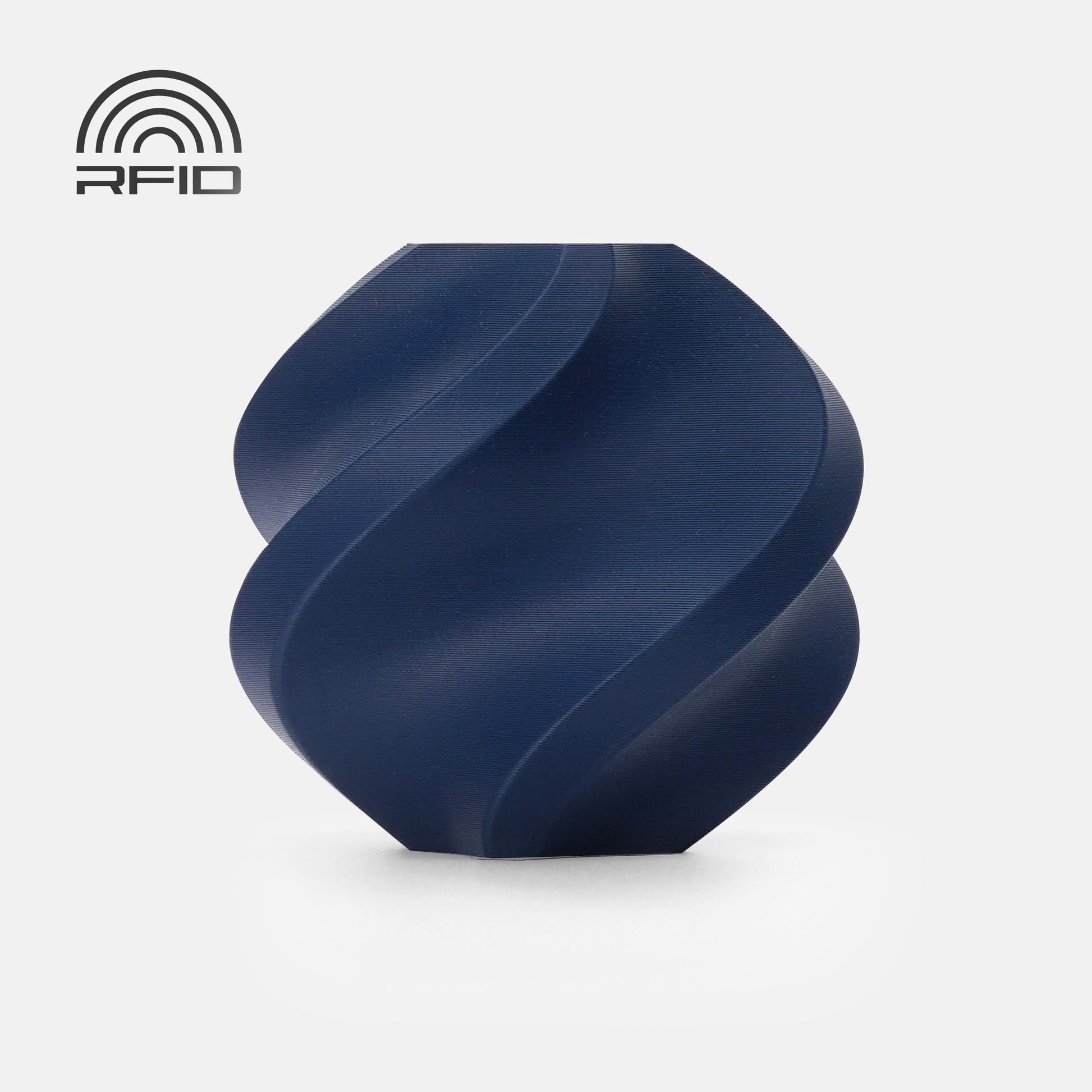 A dark blue, spiral-shaped BambuLab Filament Matte by 3D Printing Perth - Cirrus Link with a biodegradable matte surface is displayed against a white background. An RFID symbol appears in the top left corner.