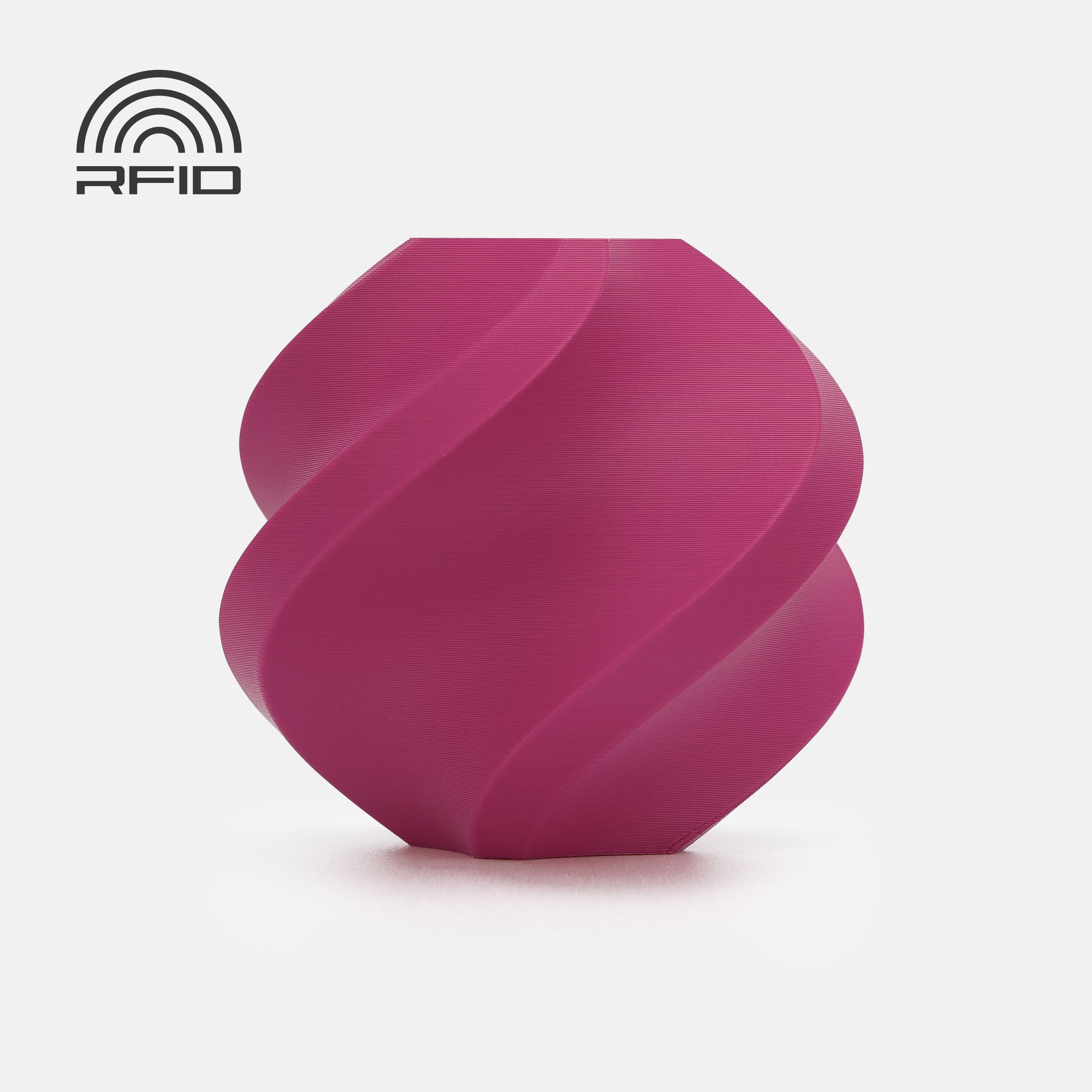 A magenta, spiral-shaped BambuLab Filament Matte by 3D Printing Perth - Cirrus Link with a matte surface and an RFID symbol in the top left corner, set against a white background.