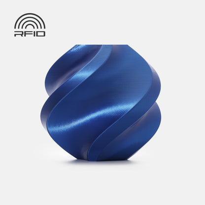 A smooth, blue, spiral-shaped object—likely made with BambuLab PLA Silk+ filament from 3D Printing Perth - Cirrus Link—rests on a white background, featuring an RFID symbol in the top left corner.