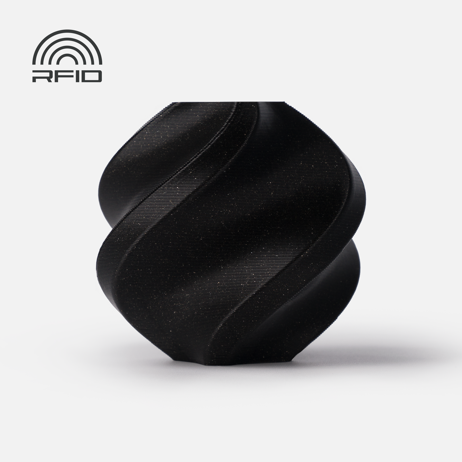 A matte black, twisted geometric object 3D printed from Bambu Lab Filament - PLA Sparkle by 3D Printing Perth - Cirrus Link sits on a white background; an RFID symbol appears in the top left corner.