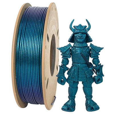 A spool of Toyar's Filament - Toyar PLA Magic Color 1.75mm (Sparkling) rests by a beautifully crafted samurai figurine, displaying stunning metallic effects in its blue hue.