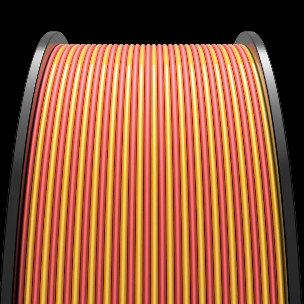 Close-up of a row of tightly packed, alternating yellow and red MakerHero DuoPLA+ 1.75mm 3D Printing Filament cables against a dark, rounded background.