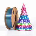 A spool of Toyar PLA Silk Rainbow 1.75mm 3D Printing Filament sits beside a multicolored, geometric, 3D-printed tree-shaped object on a white background.