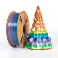A spool of Toyar PLA Silk Rainbow 1.75mm filament sits beside a vibrant geometric tree sculpture, both showcasing the stunning colors achievable with Toyar’s rainbow 3D printing filament.