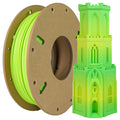 A spool of Toyar PLA Matte Rainbow 1.75mm Filament sits beside a green and yellow 3D-printed multi-level gothic-style tower.
