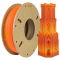 A spool of Toyar PLA Matte Rainbow 1.75mm Filament is displayed beside an orange and yellow Gothic-style 3D-printed tower, both showcasing the brand's smooth matte finish.