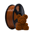 A spool of Flashforge PLA 1.75mm Basic Colour 3D Printing Filament in brown sits beside a small, intricately patterned 3D-printed bear figurine made in the same color.